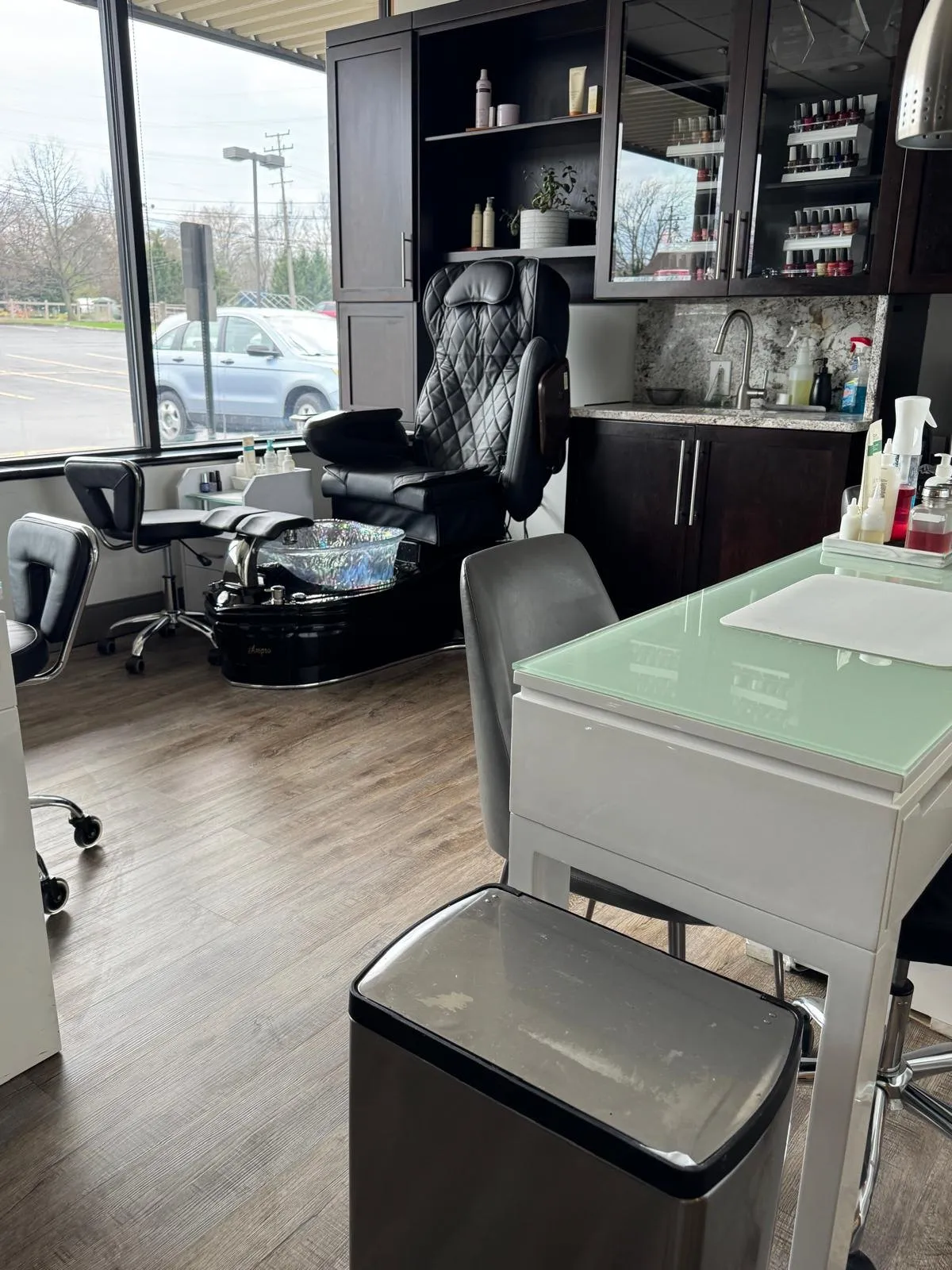 Clean pedicure chair and manicure station in a bright nail salon